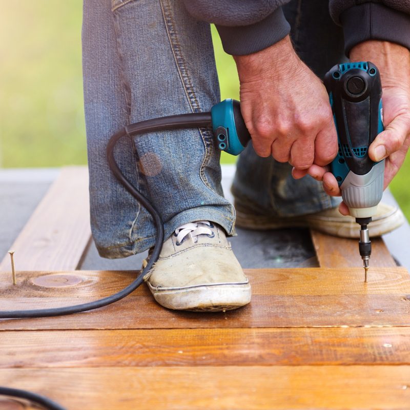 Handymen installing wooden flooring